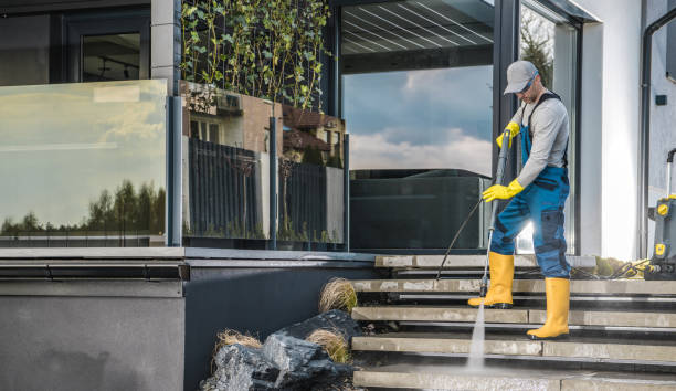 Brightness window cleaning team performing a power wash service at a customers home.