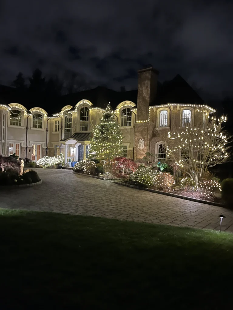 A NY home decorated with christmas lights, installed by Brightness Window Cleaning
